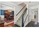 Foyer showcasing a staircase adjacent to a dining room with an ornate chandelier and hardwood floors at 2724 Saddle Ridge Lake Dr, Marietta, GA 30062