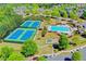 A high angle view of the community's tennis courts, playground, pool and nearby neighborhood streets at 702 Village Field Ct, Suwanee, GA 30024
