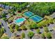 Aerial view showcasing a community pool, tennis courts, playground, and lush greenery at 702 Village Field Ct, Suwanee, GA 30024