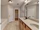 Bathroom featuring double sinks, granite counters, and a nearby tub and closet at 702 Village Field Ct, Suwanee, GA 30024