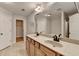 Bathroom featuring double sinks, granite counters, and a walk in closet at 702 Village Field Ct, Suwanee, GA 30024