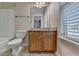 Full bathroom featuring wood vanity, bath tub, and a neutral color palette at 702 Village Field Ct, Suwanee, GA 30024