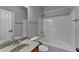 This bathroom features a shower/tub combo, vanity and granite countertop at 702 Village Field Ct, Suwanee, GA 30024