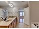 Bathroom featuring double sinks, granite counters, and a view into the bedroom and walk-in closet at 702 Village Field Ct, Suwanee, GA 30024