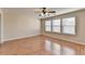 Spacious bedroom featuring a ceiling fan, hardwood floors, and natural light from the windows at 702 Village Field Ct, Suwanee, GA 30024