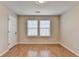 Sunny bedroom with wood flooring, double windows providing ample natural light at 702 Village Field Ct, Suwanee, GA 30024