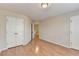 Spacious bedroom with wood floors and multiple closets offering plenty of storage at 702 Village Field Ct, Suwanee, GA 30024