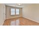 Bright bedroom with wood flooring, large window, and neutral color scheme at 702 Village Field Ct, Suwanee, GA 30024
