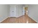 Neutral bedroom featuring wood floors, double closets, and access to hallway at 702 Village Field Ct, Suwanee, GA 30024
