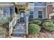 Inviting entryway with well-manicured bushes leading to a stylish townhome entrance at 702 Village Field Ct, Suwanee, GA 30024