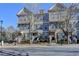 Attractive townhomes with two stories and well-maintained landscaping offer appealing curb appeal at 702 Village Field Ct, Suwanee, GA 30024