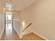 Hallway with wood floors showcasing access to multiple rooms and staircase at 702 Village Field Ct, Suwanee, GA 30024