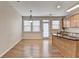 Open-concept kitchen featuring an island with sink, wood cabinets and stainless appliances at 702 Village Field Ct, Suwanee, GA 30024