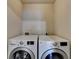 Laundry room featuring white front load washer and dryer units at 702 Village Field Ct, Suwanee, GA 30024