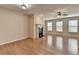 Bright and airy living room features beautiful hardwood floors and a cozy fireplace at 702 Village Field Ct, Suwanee, GA 30024