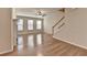 Sun-filled living room boasts hardwood floors, a cozy fireplace, and staircase at 702 Village Field Ct, Suwanee, GA 30024