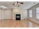 Spacious living room featuring hardwood floors, a fireplace, and ample natural light at 702 Village Field Ct, Suwanee, GA 30024