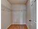 Walk-in closet featuring hardwood floors and wire shelving at 702 Village Field Ct, Suwanee, GA 30024