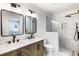 Well-appointed bathroom with a dual sink vanity, modern fixtures, and a walk-in shower with tiled walls at 888 Old Tucker Rd, Stone Mountain, GA 30087