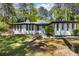 Charming single-story home with unique architectural details and a beautifully landscaped front yard at 888 Old Tucker Rd, Stone Mountain, GA 30087