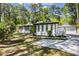 Attractive exterior view featuring a well-maintained yard and a private driveway leading to a detached garage at 888 Old Tucker Rd, Stone Mountain, GA 30087