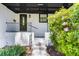 Inviting front porch with black railing, leading to the stylish front door and landscaped surroundings at 888 Old Tucker Rd, Stone Mountain, GA 30087