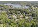 An aerial view of homes nestled amongst mature trees on a lake with boat docks and beautiful blue water at 1050 Signal Pointe, Alpharetta, GA 30005