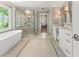 Luxurious bathroom featuring a soaking tub, glass shower, and double vanity sinks at 1050 Signal Pointe, Alpharetta, GA 30005