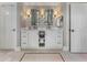 Bathroom with double vanity, storage, decorative mirrors, and a door leading to another room at 1050 Signal Pointe, Alpharetta, GA 30005