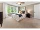 Cozy bedroom featuring a comfortable bed, large windows, and a ceiling fan at 1050 Signal Pointe, Alpharetta, GA 30005
