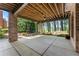 Spacious covered patio with string lights, a ceiling fan and a porch swing facing the backyard at 1050 Signal Pointe, Alpharetta, GA 30005