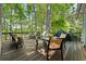 Outdoor deck with seating, grill, and view of mature trees providing shade and privacy at 1050 Signal Pointe, Alpharetta, GA 30005