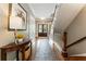 Inviting entryway with hardwood floors, console table, and staircase at 1050 Signal Pointe, Alpharetta, GA 30005