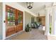 Elegant double front doors with glass panels leading to a covered porch area with seating at 1050 Signal Pointe, Alpharetta, GA 30005
