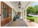 Charming front porch featuring brick flooring, stately columns and wood double-door entry with sidelights at 1050 Signal Pointe, Alpharetta, GA 30005
