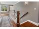 Bright hallway with hardwood floors, white banister, and natural light from a window at 1050 Signal Pointe, Alpharetta, GA 30005