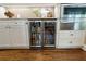 Modern kitchen features a stainless steel beverage fridge with glass doors at 1050 Signal Pointe, Alpharetta, GA 30005