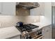 Modern kitchen features a stainless steel gas range and tiled backsplash at 1050 Signal Pointe, Alpharetta, GA 30005