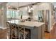 Modern kitchen featuring stainless steel appliances, a large island with seating, and stylish pendant lighting at 1050 Signal Pointe, Alpharetta, GA 30005