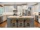 Open kitchen with stainless steel appliances, a spacious island, and ample cabinet space for storage at 1050 Signal Pointe, Alpharetta, GA 30005