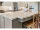 Close-up of the kitchen island featuring a marble countertop, seating, and custom cabinetry at 1050 Signal Pointe, Alpharetta, GA 30005