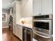 Modern kitchen features built-in stainless steel appliances and beverage fridge at 1050 Signal Pointe, Alpharetta, GA 30005
