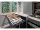 Laundry room with pull out ironing board and new washer dryer at 1050 Signal Pointe, Alpharetta, GA 30005
