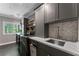 Modern laundry room with gray cabinets, stainless steel appliances, and stylish backsplash at 1050 Signal Pointe, Alpharetta, GA 30005
