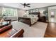 Spacious main bedroom with a large bed, ceiling fan, and natural light streaming in at 1050 Signal Pointe, Alpharetta, GA 30005