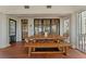 Covered porch with a large wooden dining table and bench, perfect for enjoying outdoor meals at 1050 Signal Pointe, Alpharetta, GA 30005