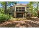 A view of the back of the home with a screened porch, a deck and a covered patio below at 1050 Signal Pointe, Alpharetta, GA 30005