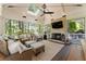 Inviting sunroom featuring a brick fireplace, skylight, comfortable seating, and scenic outdoor views at 1050 Signal Pointe, Alpharetta, GA 30005