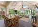 Spacious sunroom with a fireplace, skylight, ample seating, and a dining area for outdoor relaxation at 1050 Signal Pointe, Alpharetta, GA 30005