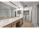 Bright bathroom featuring double sinks, a large mirror, and a laundry area at 3777 Peachtree Ne Rd # 1536, Atlanta, GA 30319